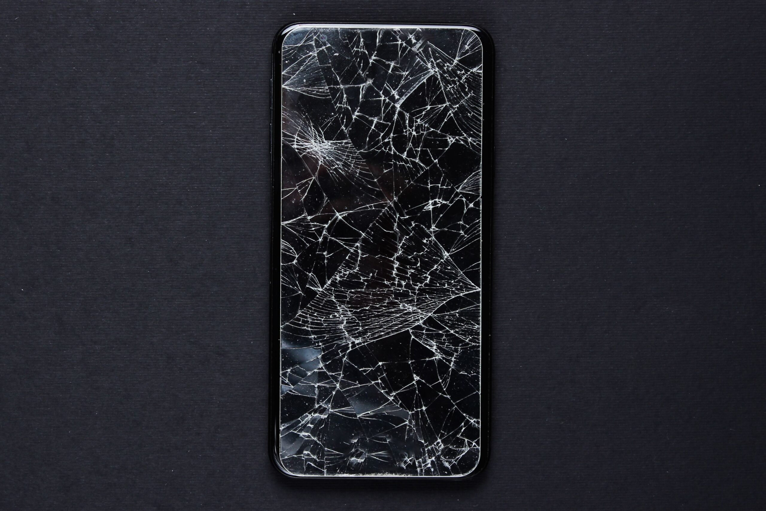 Technician performing cracked phone screen repair in Leeds at Ultimate Repairs