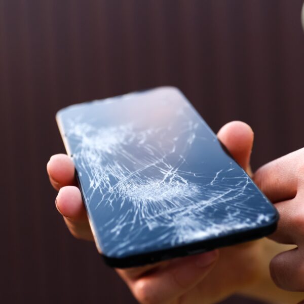 Technician performing cracked phone screen repair in Leeds at Ultimate Repairs