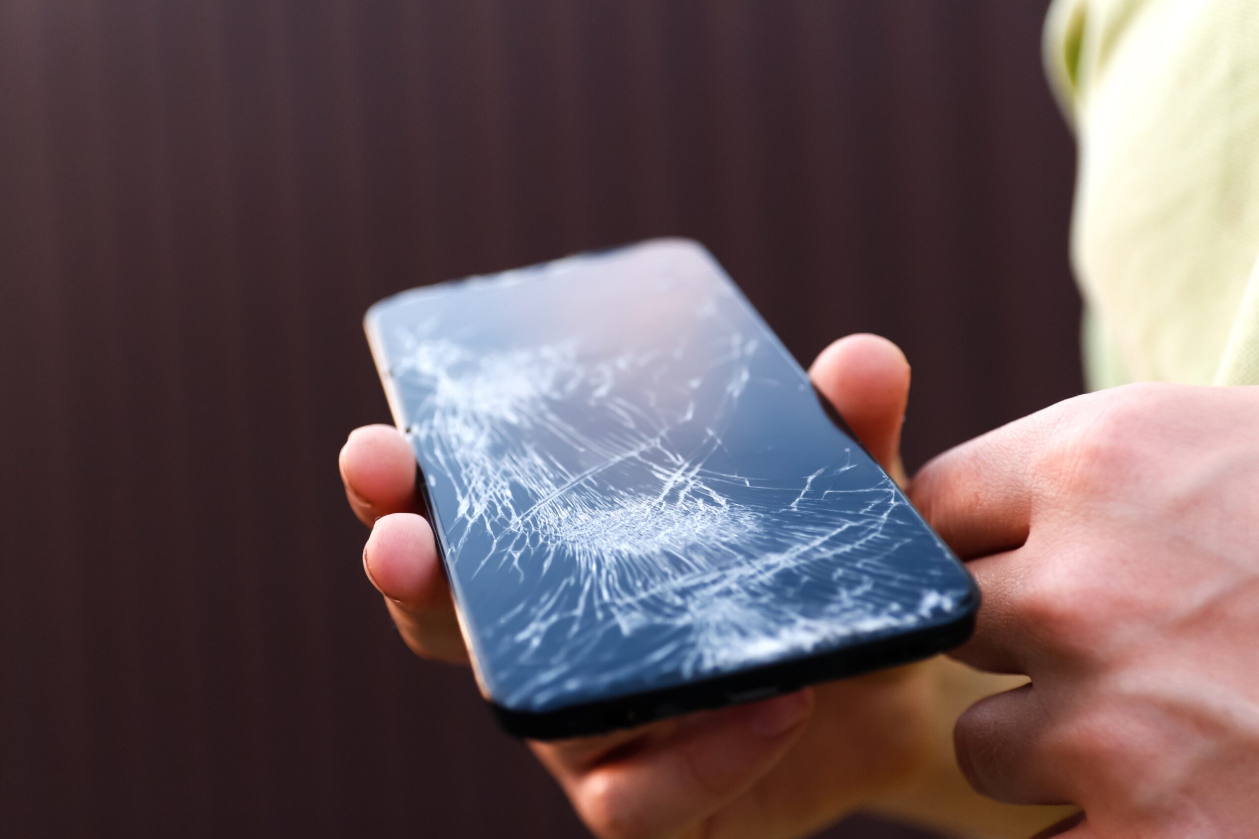 Technician performing cracked phone screen repair in Leeds at Ultimate Repairs