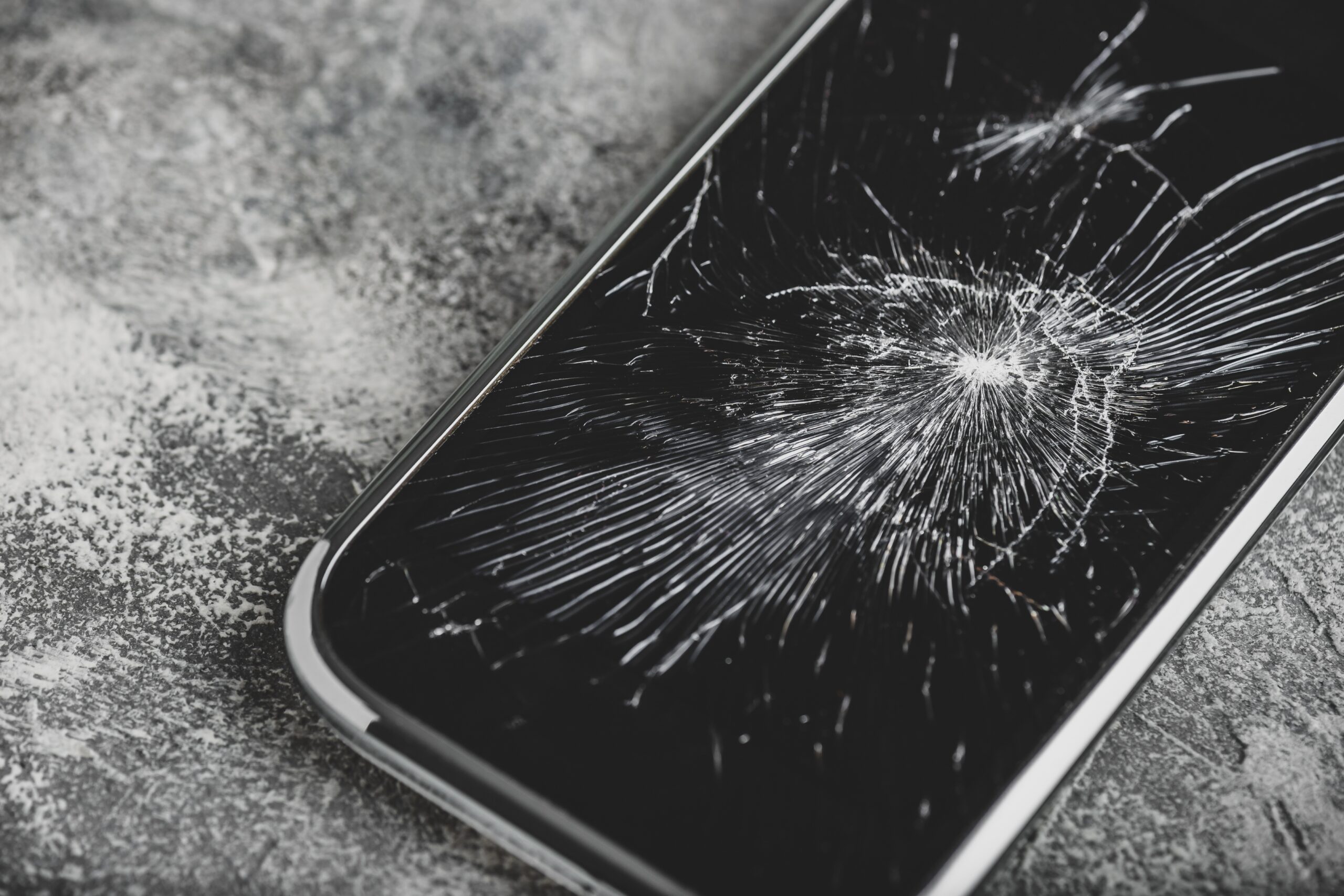 Technician performing cracked phone screen repair in Leeds at Ultimate Repairs